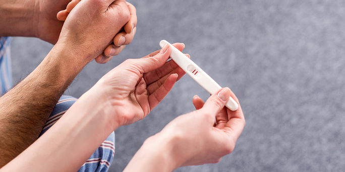 Woman wondering "how do pregnancy tests work?"