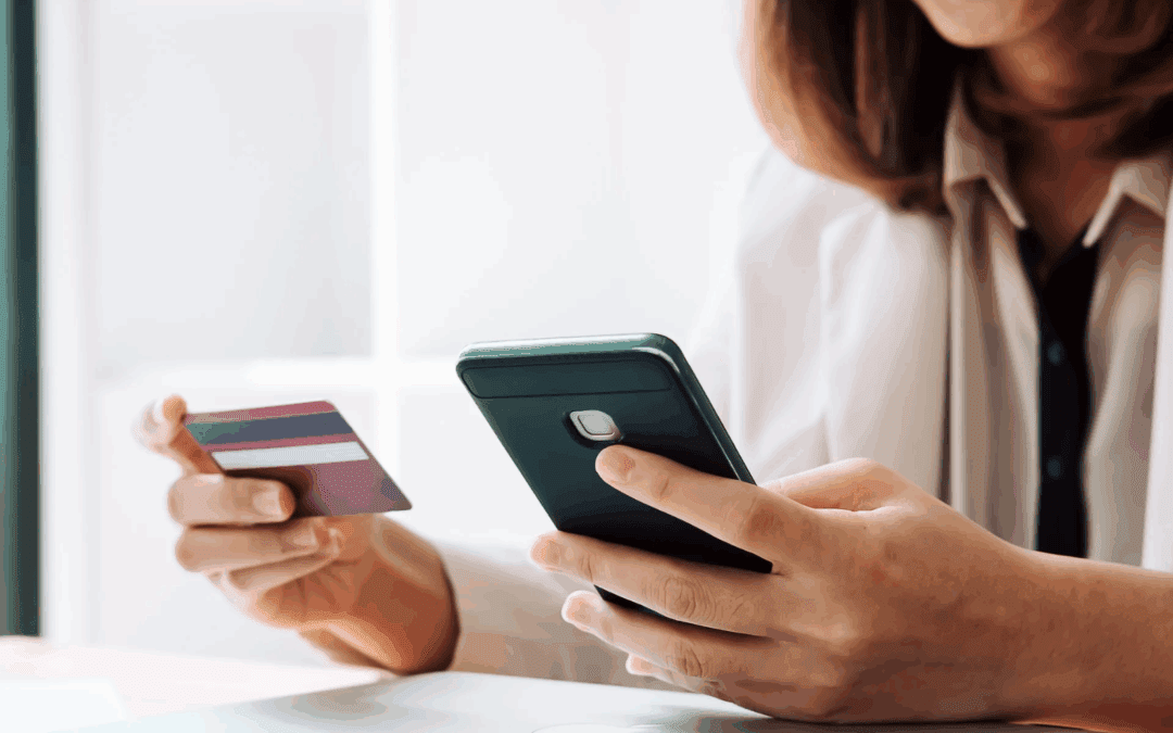 Woman viewing phone and credit card