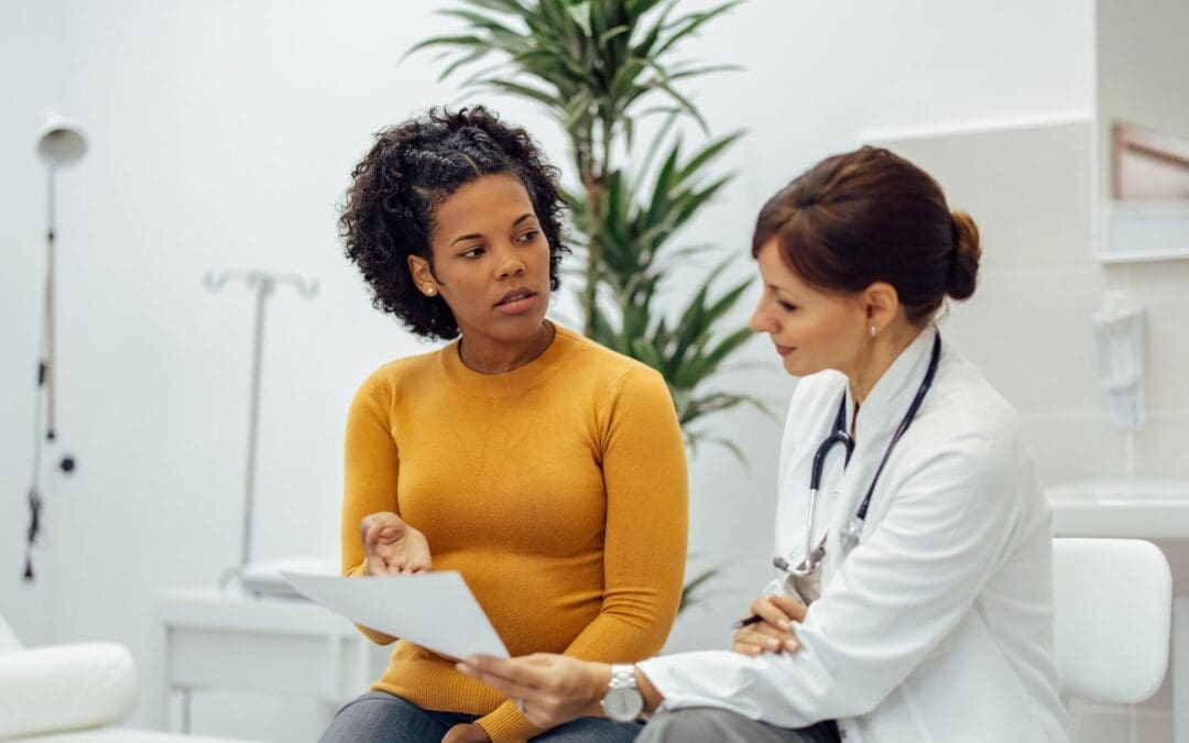 female doctor helping young female patient